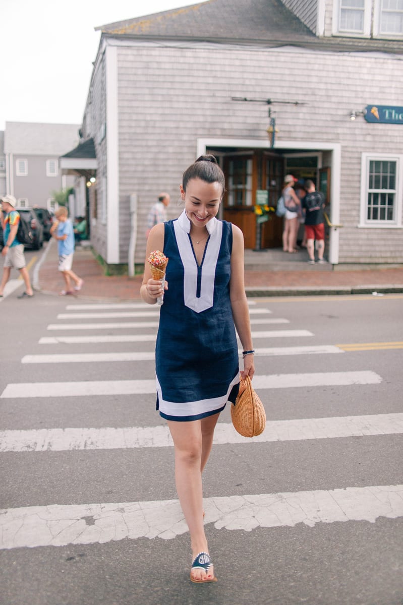 blogger Carly Riordan shares what to do in Nantucket including the Juice Bar while wearing a navy and white sail to sable dress and navy and white monogrammed Jack Rogers sandals