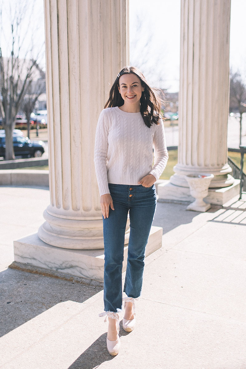New Jersey blogger Carly Heitlinger is wearing Gal Meets Glam x Margaux blush espadrilles, button-fly jeans, and a cream cableknit cashmere sweater
