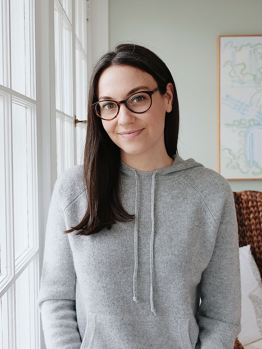New Jersey blogger Carly Heitlinger wears a grey cashmere hoodie by a window