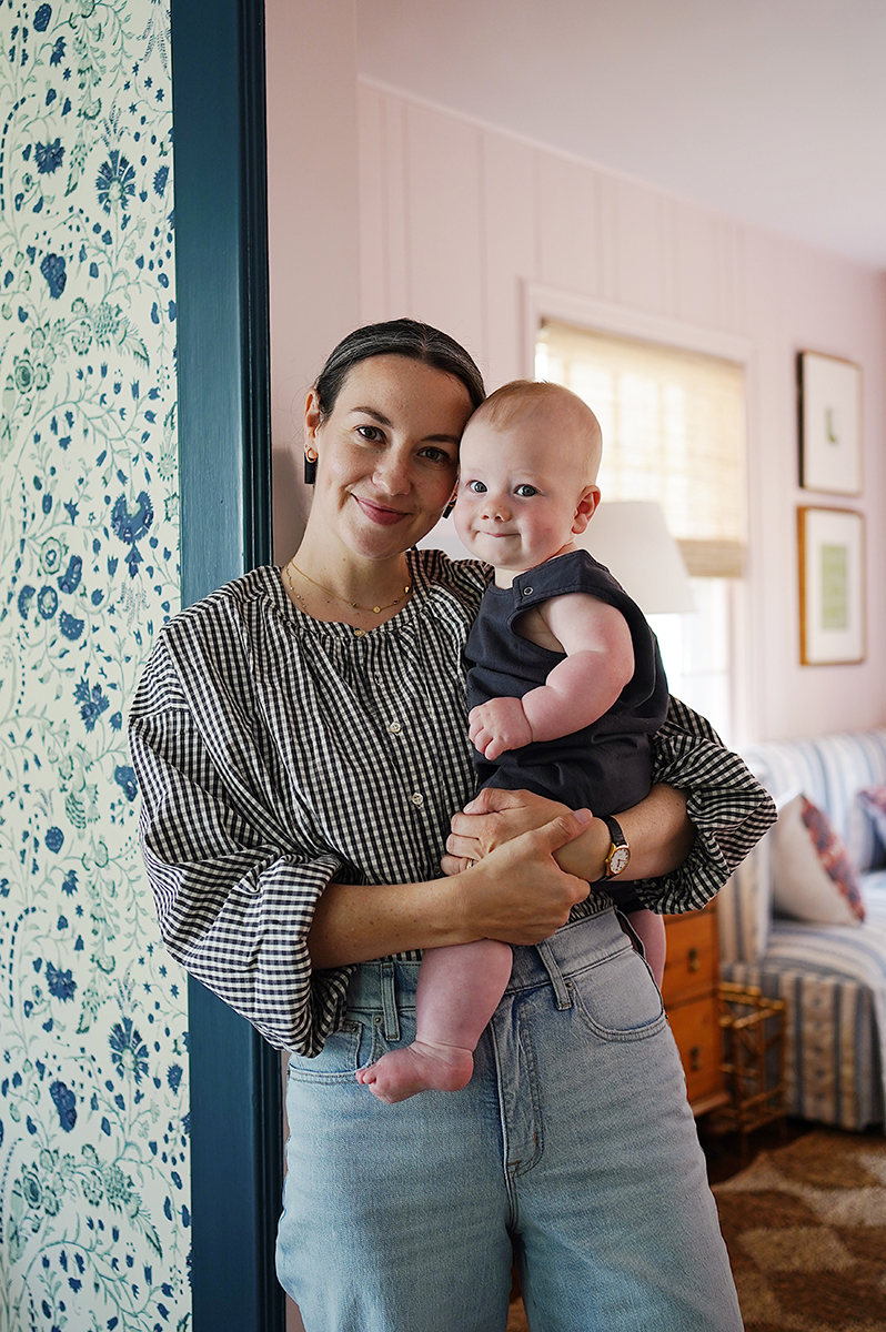 Carly holding her son Rory in the living room