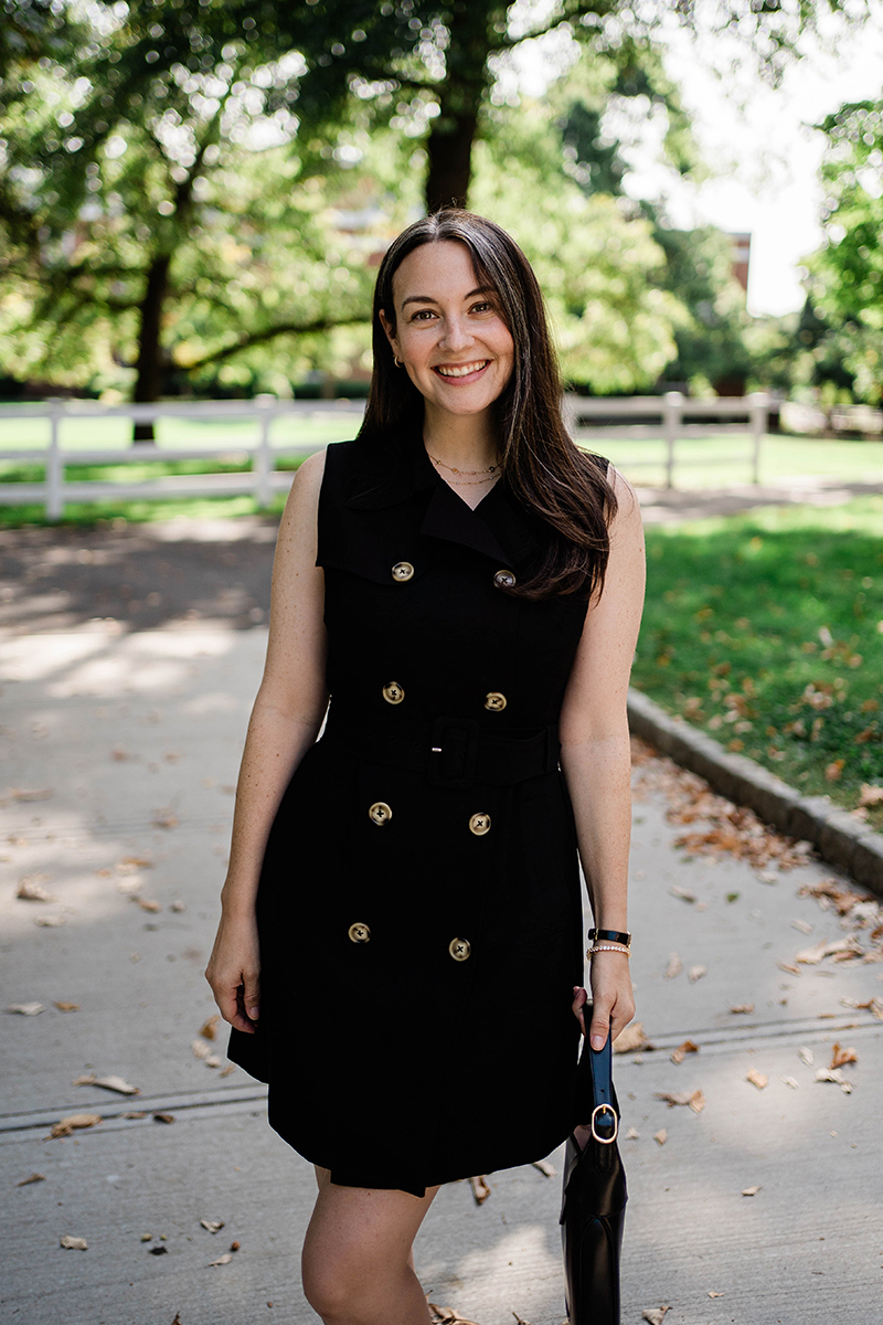 Carly Riordan wearing a black double breasted dress from Tuckernuck. 