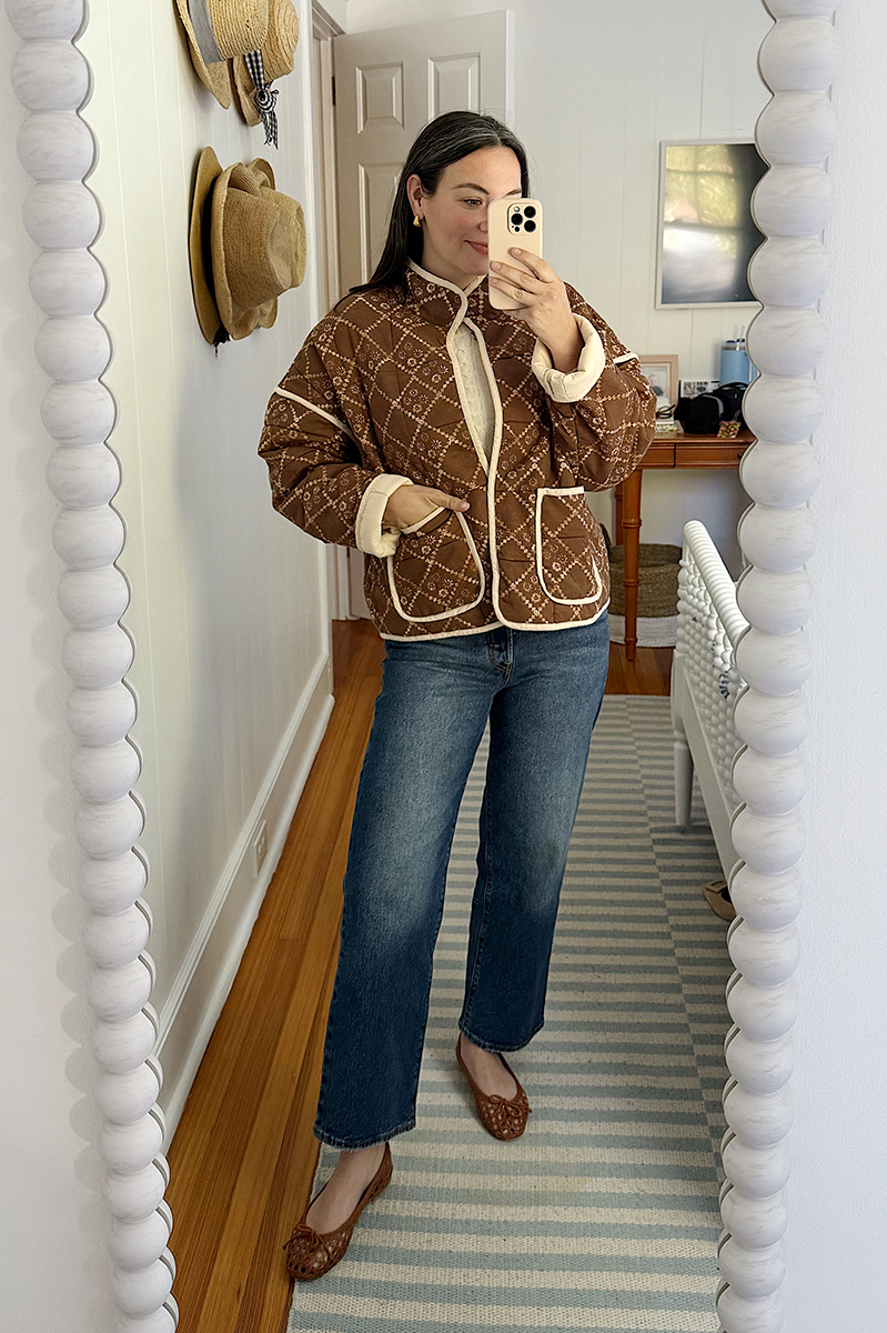 Carly Riordan in a mirror selfie wearing a Free people quilted jacket.