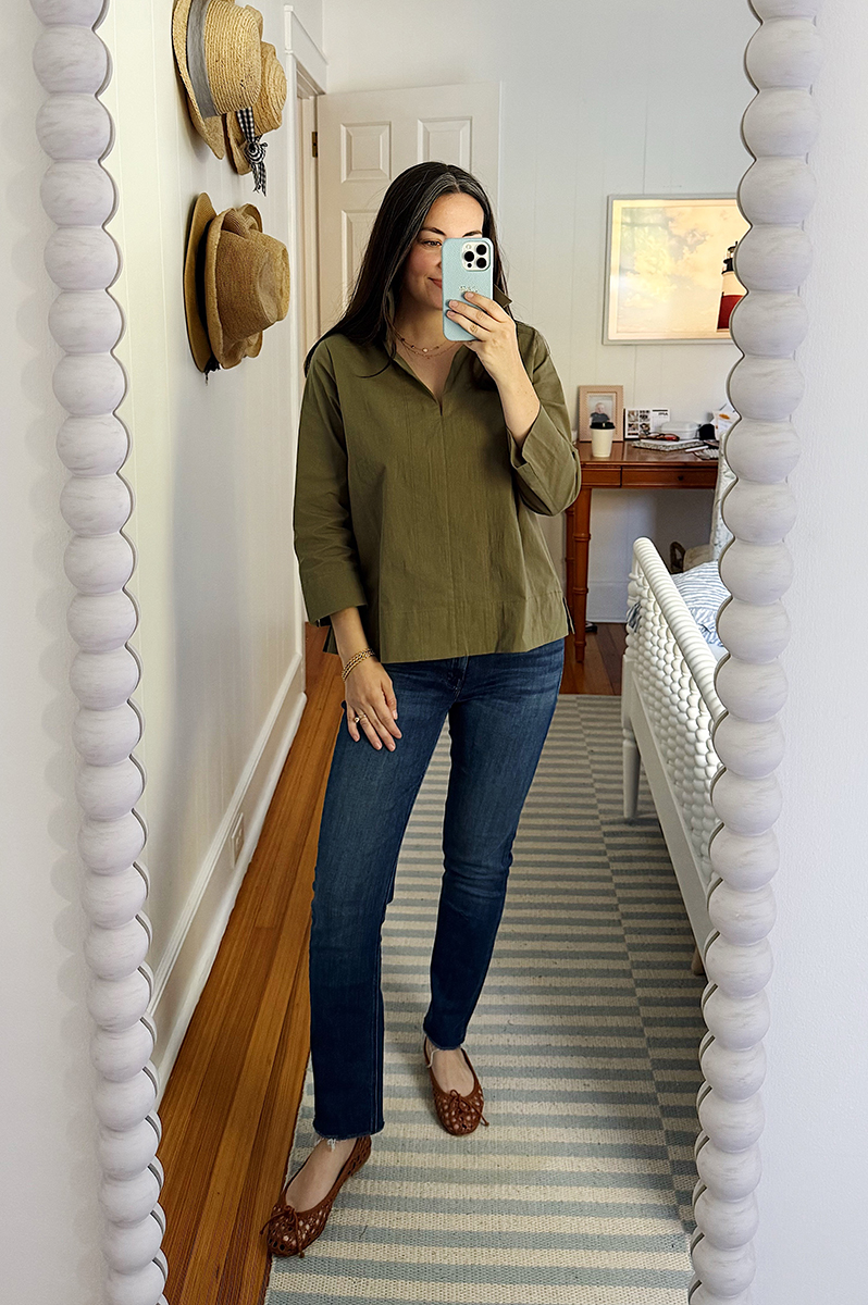 Carly Riordan wearing a green blouse and dark jeans.