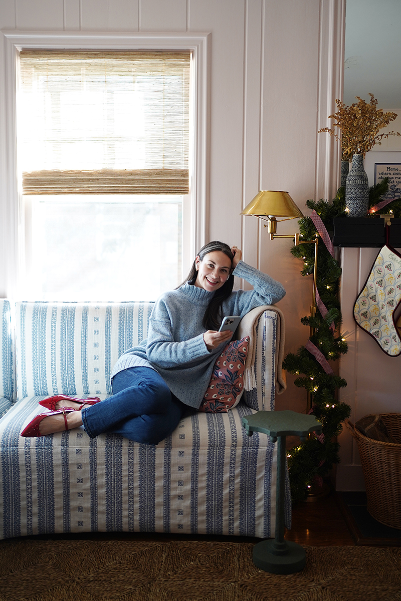 Carly Riordan sitting on the couch listening to an audiobook!