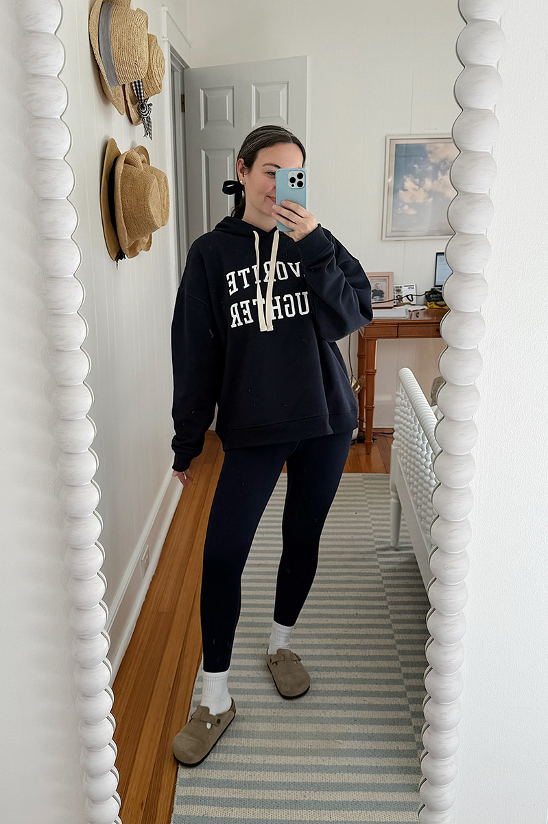 Carly Riordan taking a mirror selfie wearing a favorite daughter sweatshirt.