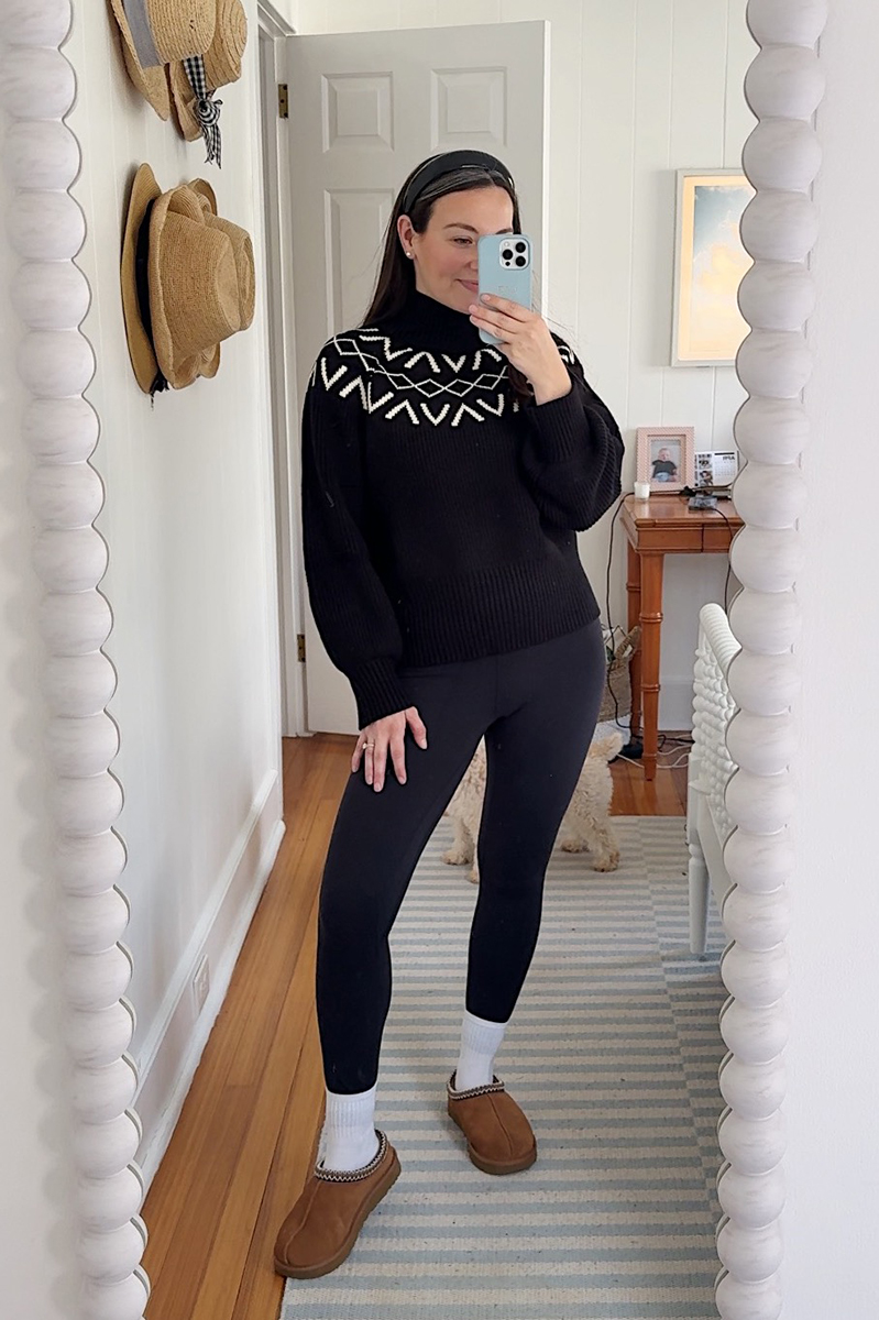 Carly Riordan taking a mirror selfie wearing a Varley fair isle sweater.