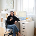 Carly Riordan listening to an audiobook at her desk