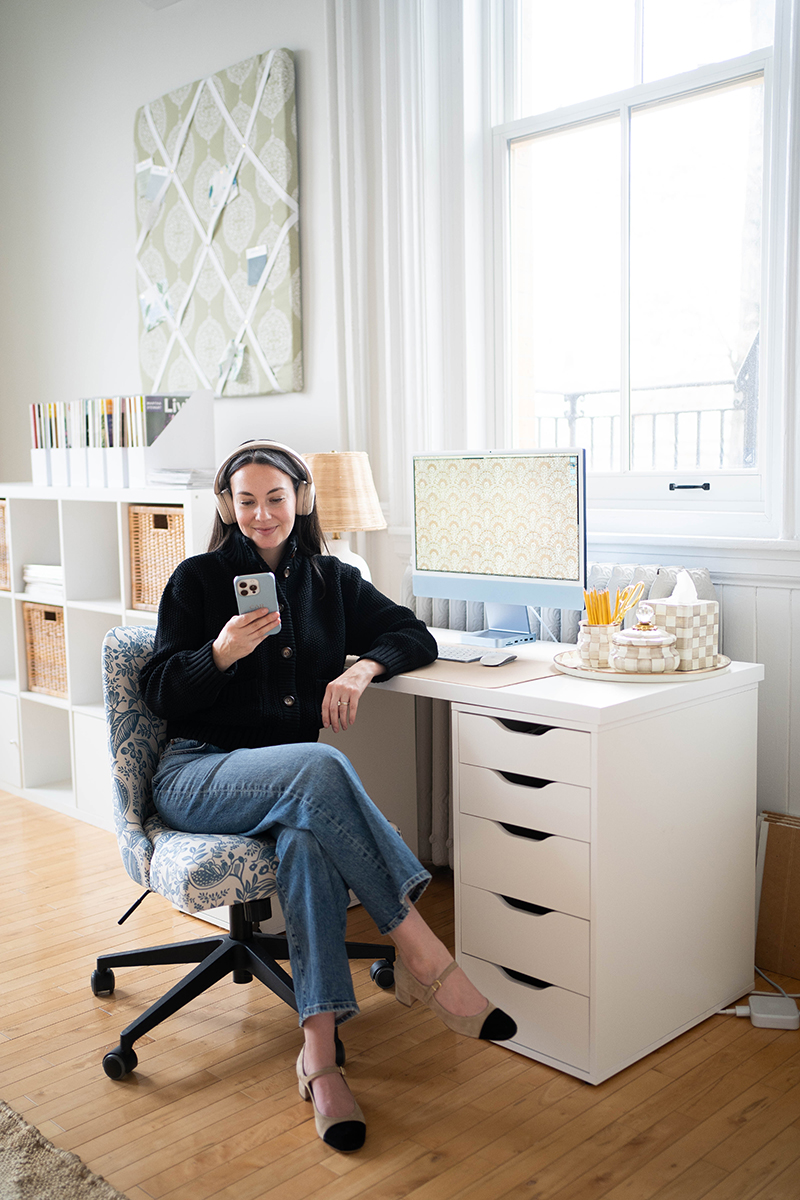 Carly Riordan listening to an audiobook at her desk