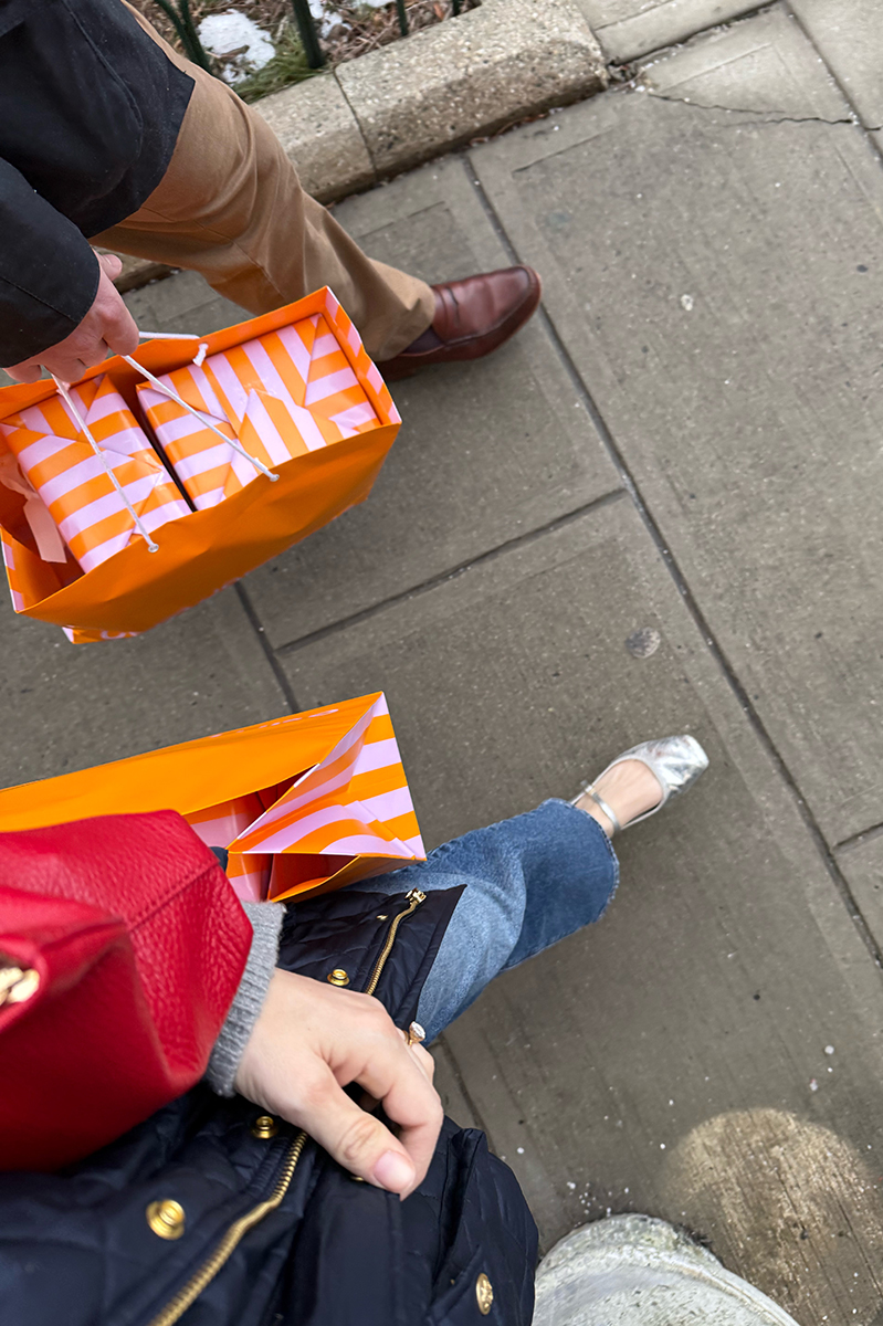 A couple walking carrying colorful shopping bags