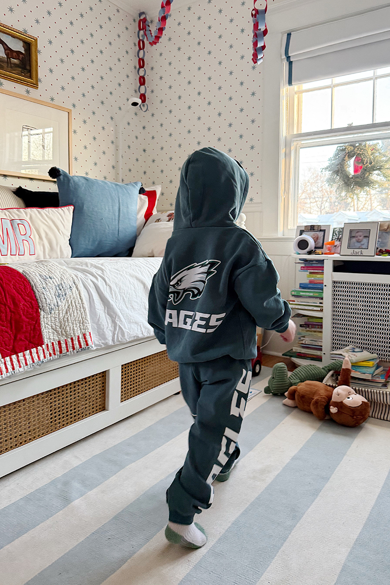 A toddler wearing an Eagles sweatsuit