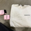 Soto Method Sweatshirt and hand weights on the floor of a gym