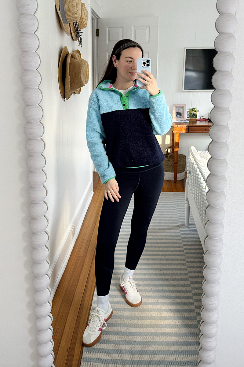 Carly Riordan taking a mirror selfie wearing a fleece pullover.