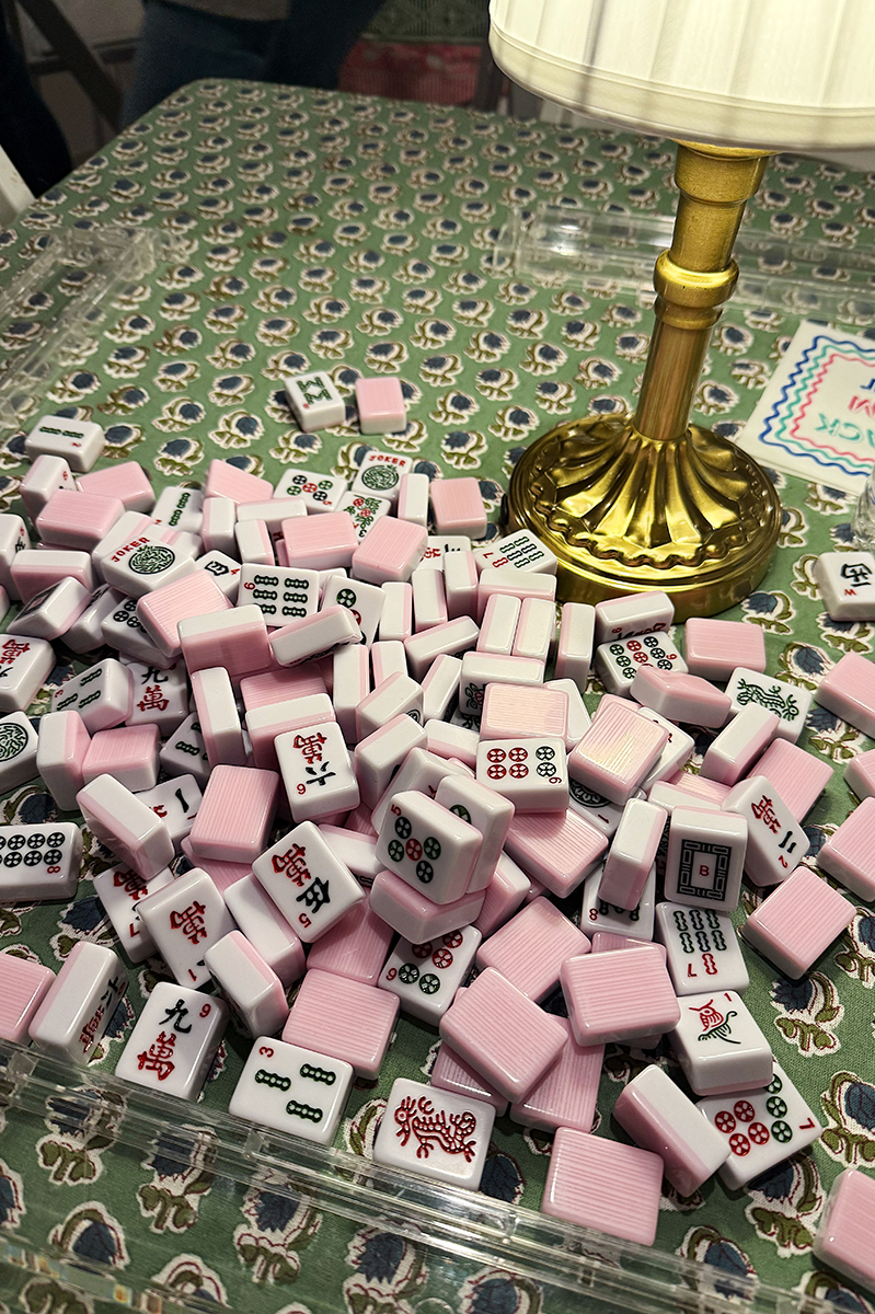 A table with mahjong tiles and a block print tablecloth