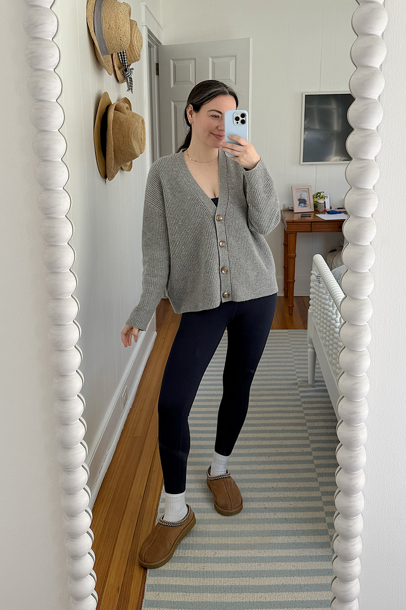 Carly Riordan taking a mirror selfie cashmere cardigan.